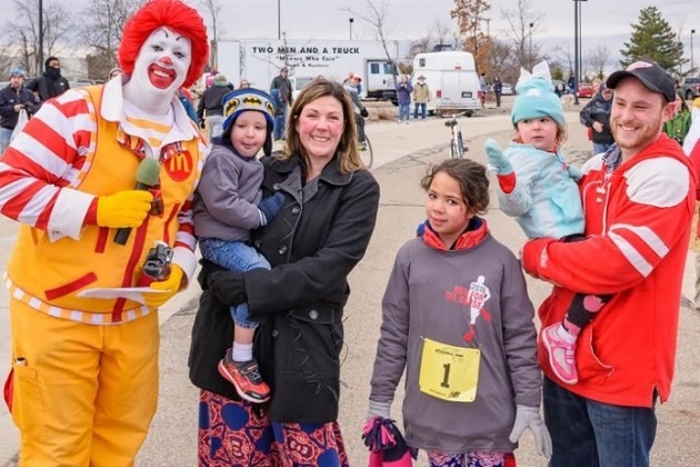 Ronald McDonald interviewing a family of five - mom, dad, two daughters and a son