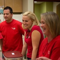 A man, Danielle, and another woman laughing with someone across the room